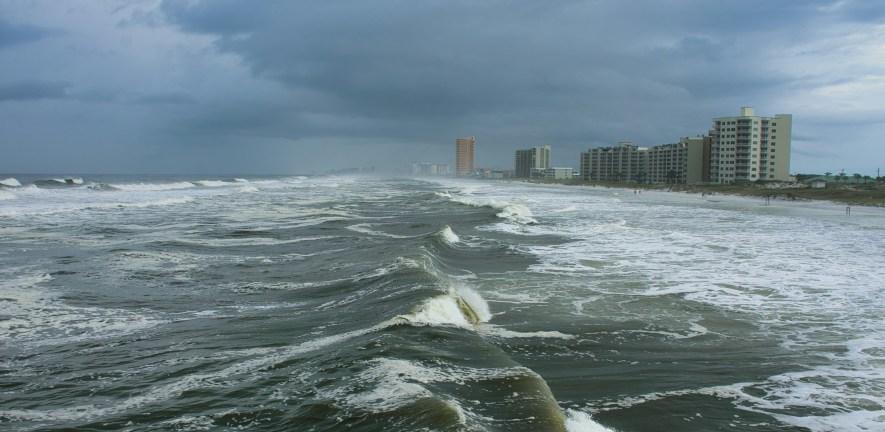 Storm clouds gathering and large waves breaking on beach in Panama City Beach, Florida, USA